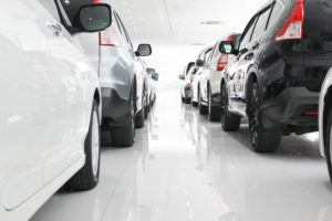 New cars parked in a row in a dealership showroom