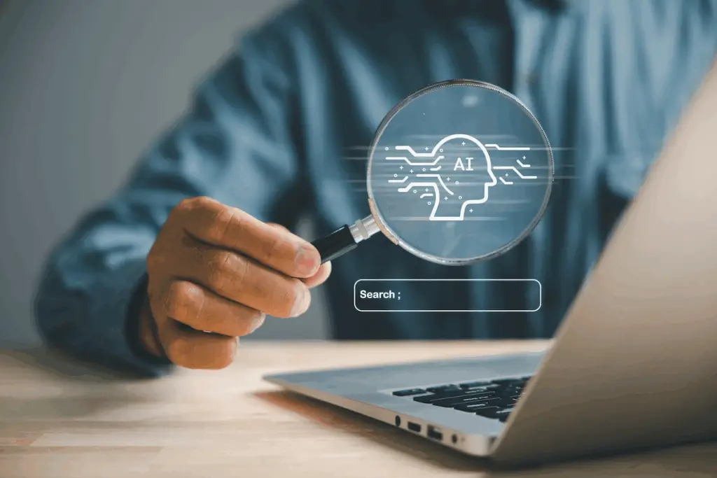 Laptop with magnifying glass showing AI search